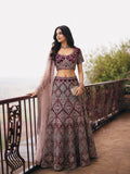 Burgundy embroidered lehenga set for women styled with a blush dupatta and detailed floral geometric embroidery