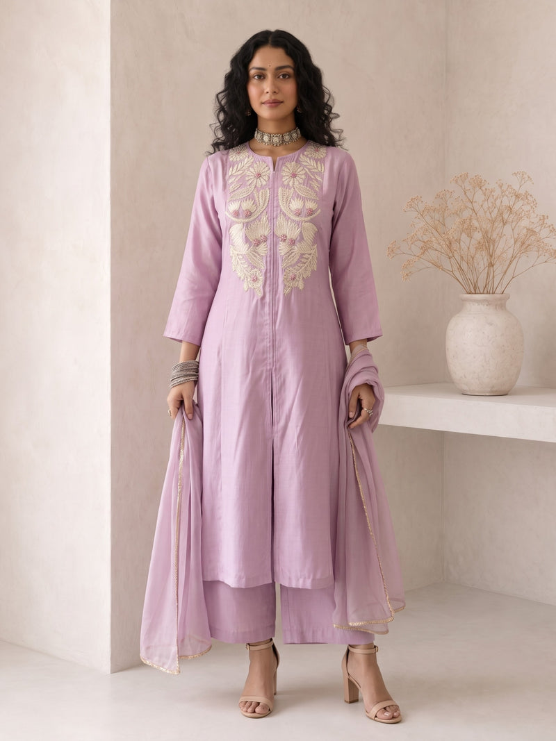 Model wearing Roselle Lavender Roman Silk Anarkali suit set with ivory floral embroidery, matching pants and organza dupatta for Raksha Bandhan, weddings and festive occasions.