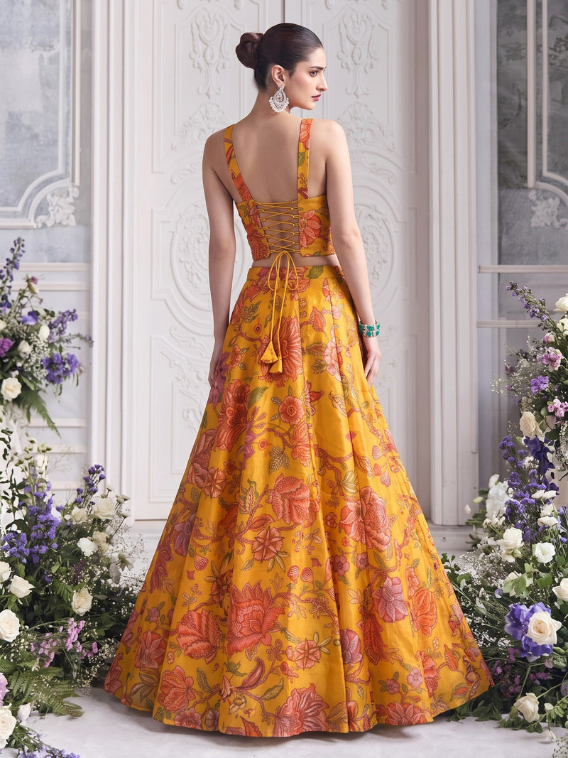Back view of Floréa Golden Marigold lehenga showcasing the adjustable lace-up corset back and full flared printed lehenga.