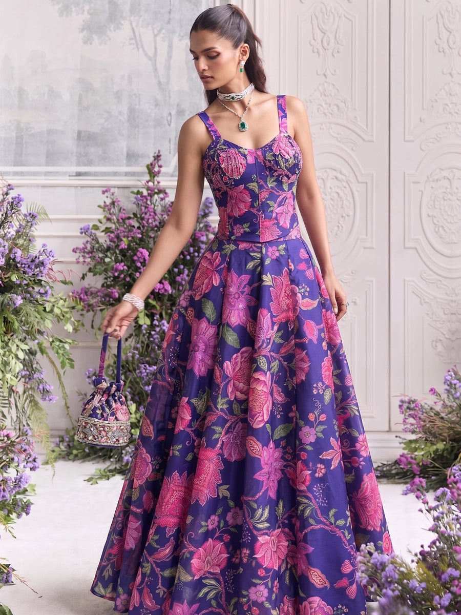 Floréa Royal Purple printed Tabby Organza lehenga set with a contemporary corset blouse and flowing floral designer lehenga for weddings and festive occasions.