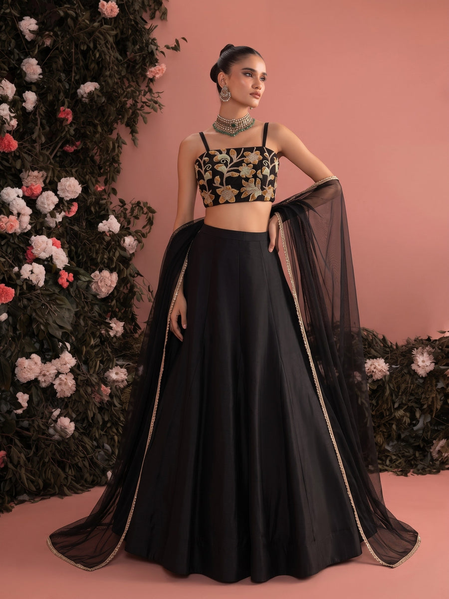 Black floral embroidered lehenga set styled for a wedding guest or festive evening look