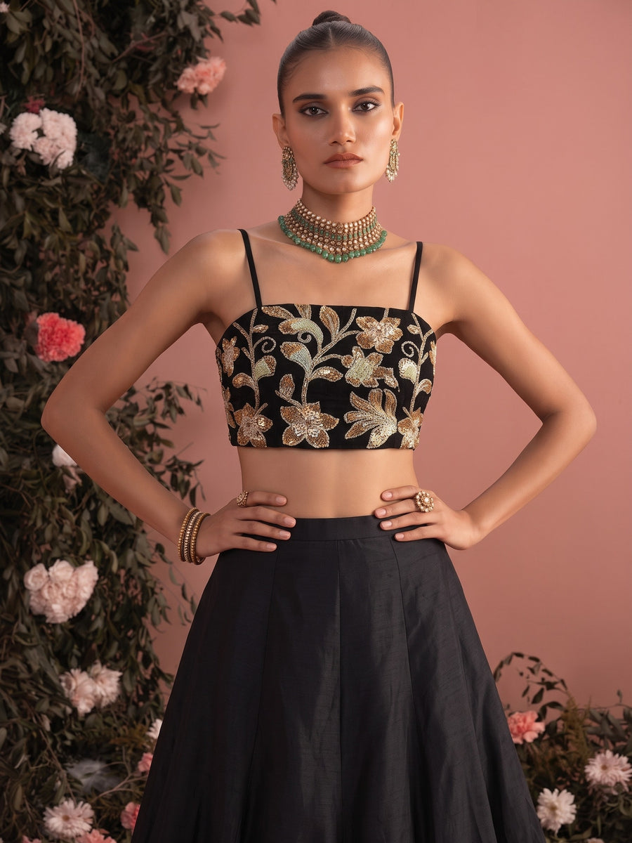 Close-up of black lehenga blouse with intricate floral bead embroidery and adjustable straps