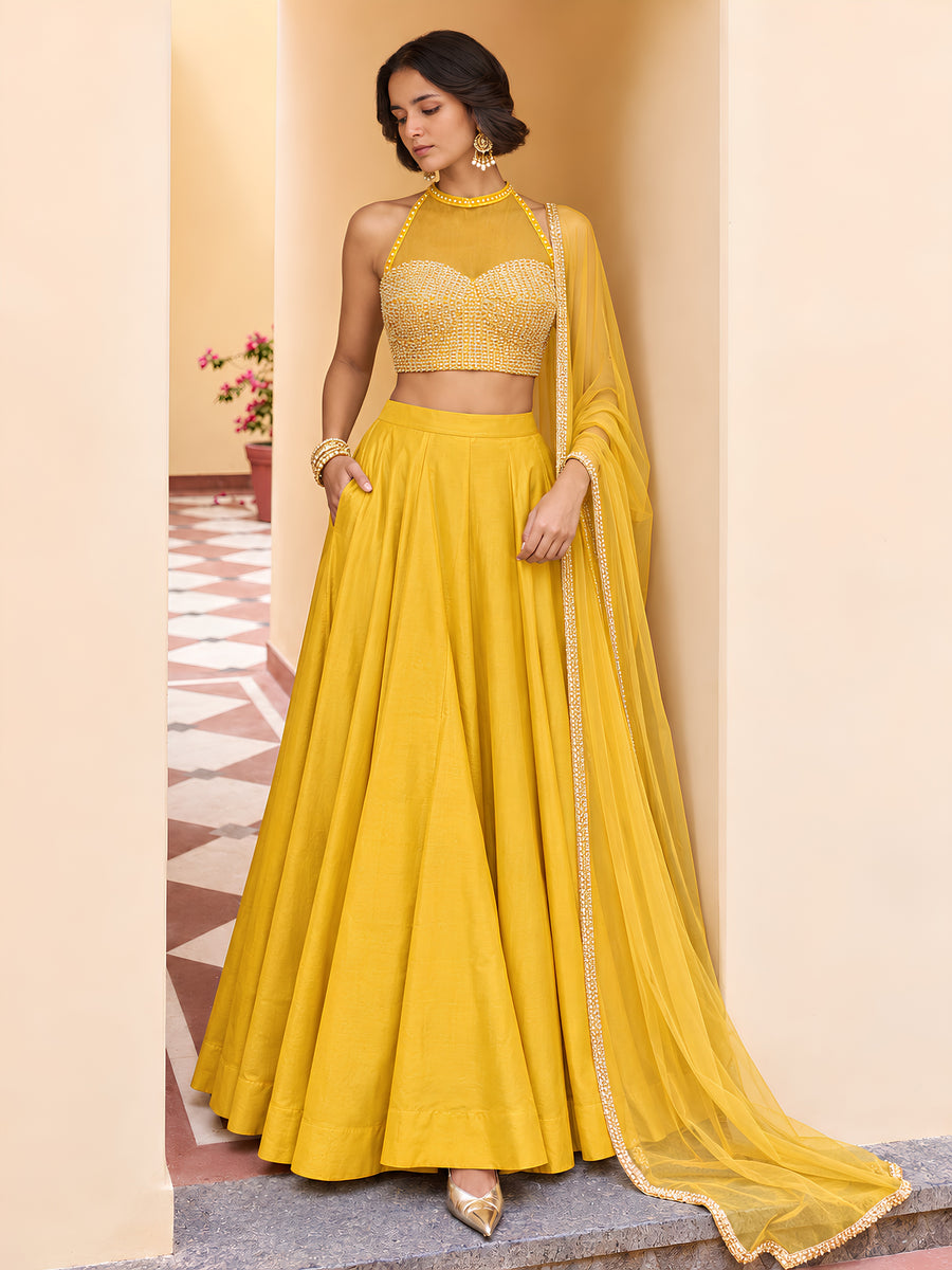 Mira yellow embellished lehenga set with beads work and with halter-style choli, full flared skirt and matching net dupatta