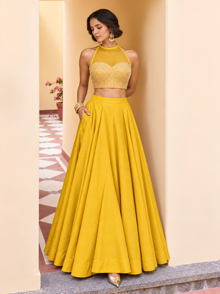 Yellow embellished lehenga set styled with a sheer net dupatta and full flowing Roman silk skirt