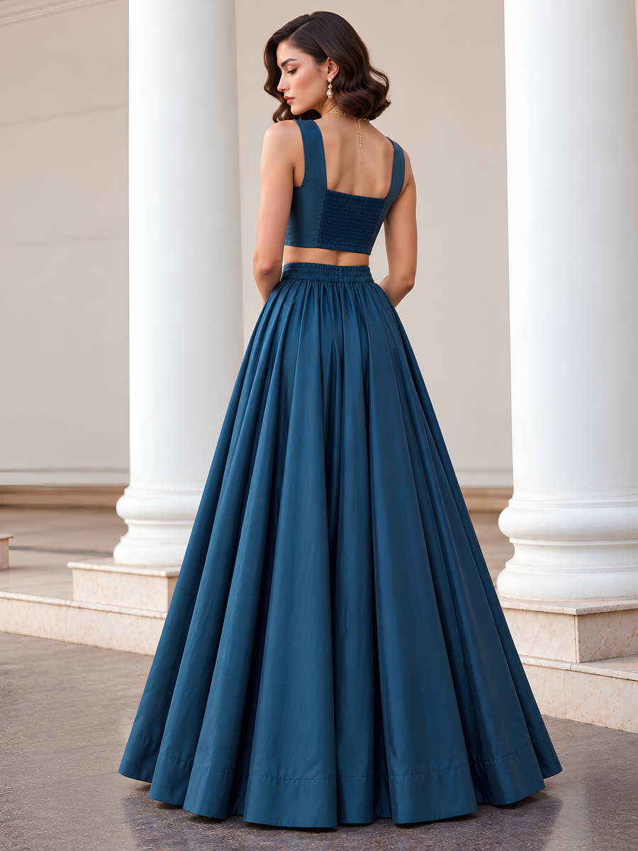 Back view of the teal blue lehenga set showing the smocked choli panel and full-length skirt